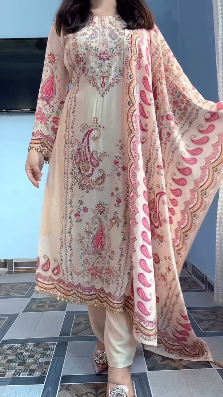 STITCHED This outfit is a beautiful example of a-style suit in a soft cream or off-white base, featuring vibrant traditional motifs. Here is a detailed description you can use for a product listing or social media post: