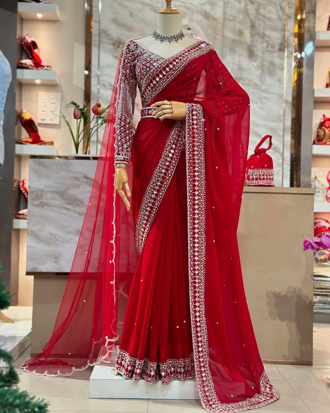 Fall in love with this stunning saree in an eye-catching shade, crafted with finesse and rich detailing. A perfect blend of grace and glam For Karwa Chauth.
