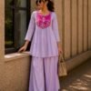 Elegant lavender kurta set with a striking magenta yoke, detailed floral embroidery, fine zari work, and pearl tassels for a rich festive look.