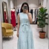 A vibrant and airy tiered midi dress, perfect for a relaxed yet stylish daytime It is a tiered sleeveless midi dress, featuring a voluminous, flared silhouette that creates a breezy, comfortable fit