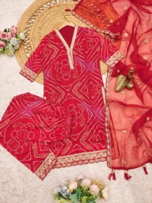 Alternative view of The ensemble presents a vibrant and traditional look, suitable for festive occasions or cultural events. The combination of the breathable cotton suit with the delicate net dupatta