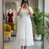 The dress features a smocked bodice,