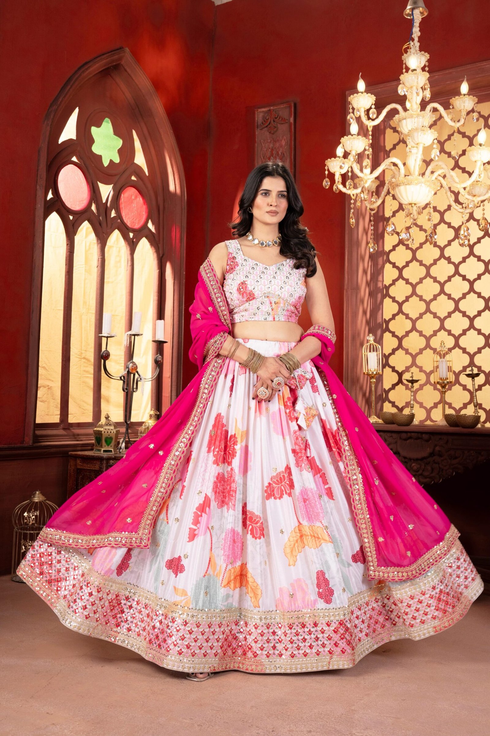 This floral white lehenga choli with a vibrant pink dupatta is the perfect blend of elegance and festive charm