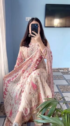 This outfit is a beautiful example of a-style suit in a soft cream or off-white base, featuring vibrant traditional motifs.