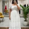 The dress features a smocked bodice, dainty puff sleeves, and a tiered midi silhouette covered in the sweetest micro-floral print. Ideal for brunch, picnics, or golden hour strolls.
