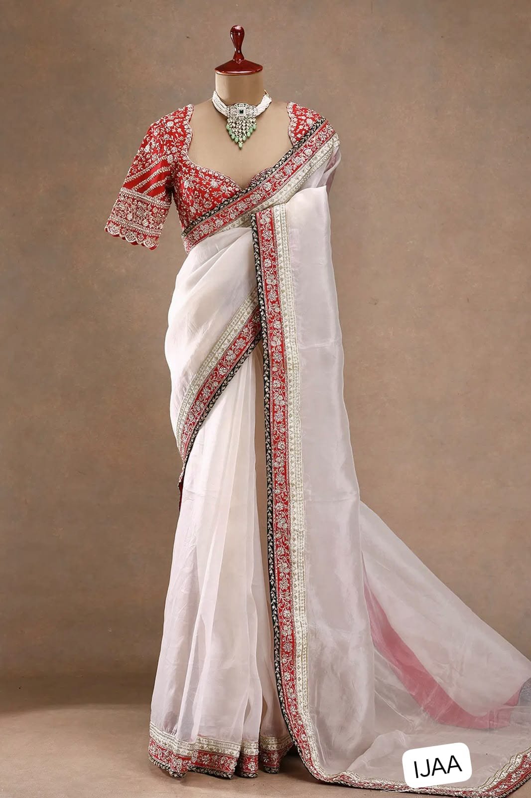 Fall in love with this stunning saree in an eye-catching shade, crafted with finesse and rich detailing. A perfect blend of grace and glam