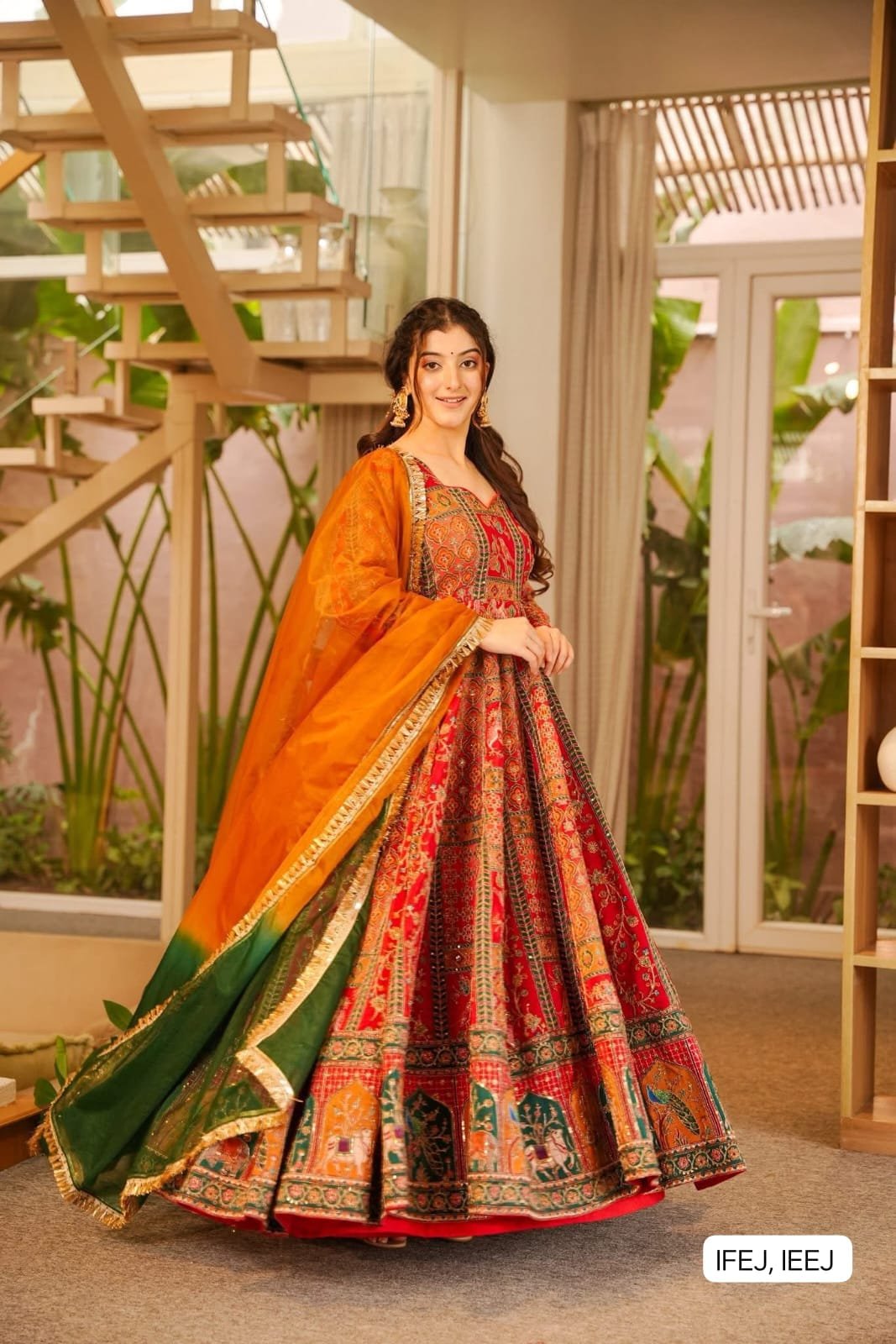 This is a stunning and festive Chinon fabric gown featuring a traditional Patola print, making it an absolute masterpiece for weddings, festivals, and special occasions.